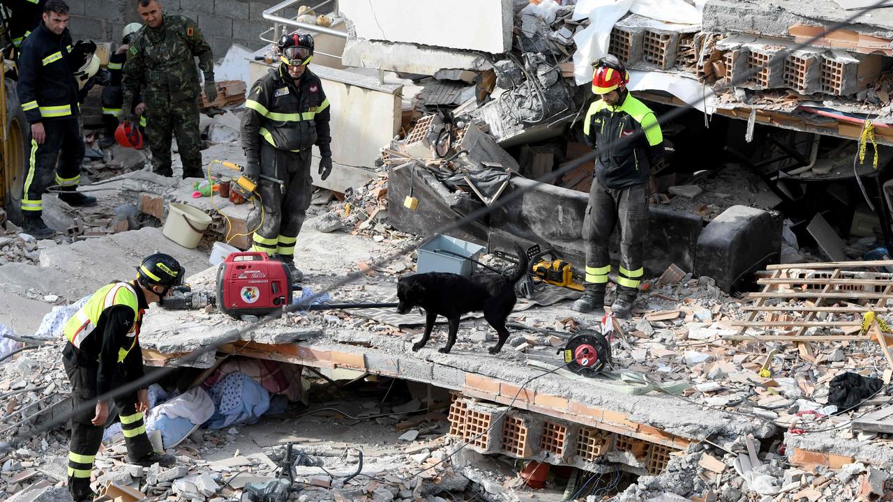 Italian rescuers search for survivors through the rubble of a collapsed building after an earthquake hit Albania. Picture: Gent Shkullaku/AFP
