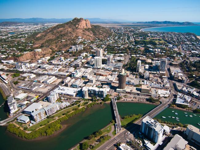 An aerial photograph of Townsville, looking across Ross Creek towards the CBD, Castle Hill and Rowes Bay.