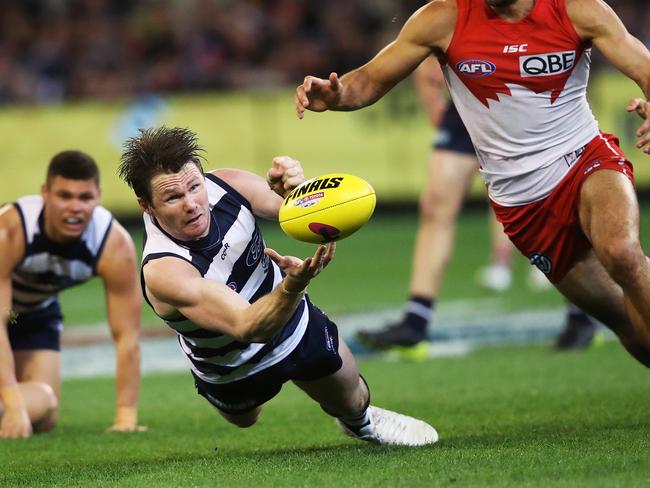 Patrick Dangerfield gets out a handball ahead of Sydney's Josh Kennedy during a Semi-Final match between the Swans and the Cats. Picture. Phil Hillyard