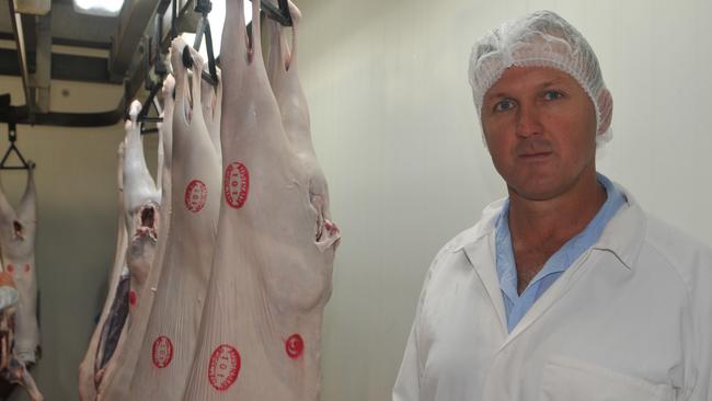 Campbell McPhee of Western Meat Exporters at Charleville in western Queensland has begun processing mutton again, as sheep numbers return to Queensland due to wild dog cluster fences. June 2017. (Note: pictured here with goat carcasses). Picture: JAMES WAGSTAFF