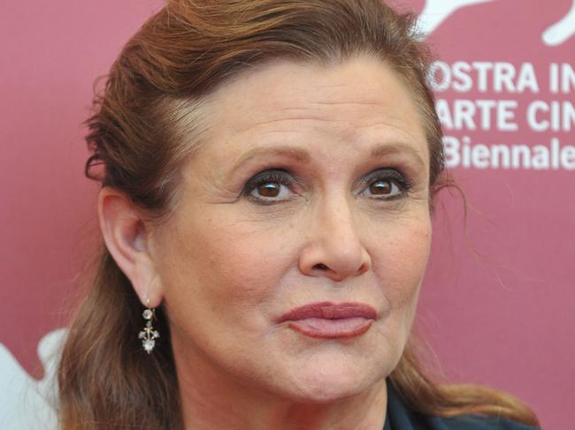 (FILES) This file photo taken on August 28, 2013 shows US actress and scriptwriter Carrie Fisher posing during a photocall of the jury on the first day of the 70th Venice Film Festival at Venice Lido.  "Star Wars" actress Carrie Fisher is in a  "stable condition" following her heart attack, her mother, actress Debbie Reynolds, tweeted on December 25 in a Christmas Day message. "Carrie is in a stable condition. If there is a change, we will share it," Reynolds said on Twitter. Fisher, 60, is in a Los Angeles hospital after suffering a massive heart attack near the end of a flight from London on December 23.  / AFP PHOTO / TIZIANA FABI