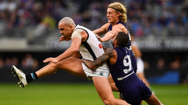 Sam Powell-Pepper is tackled by Brad Hill and Stefan Giro.