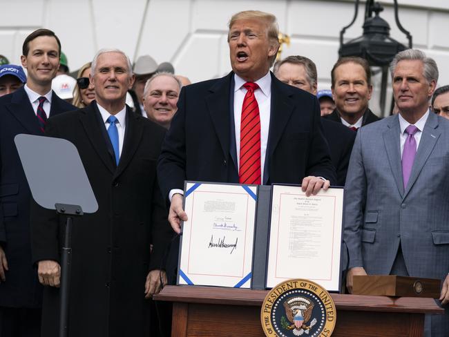 President Donald Trump shows off a new North American trade agreement with Canada and Mexico, during an event at the White House. Picture: AP