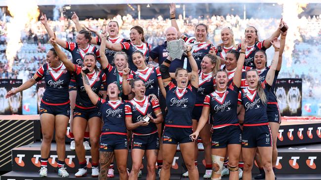 Roosters players celebrate with the NRL Women's Premiership Trophy after winning the NRLW Grand Final match between Sydney Roosters and Cronulla Sharks.