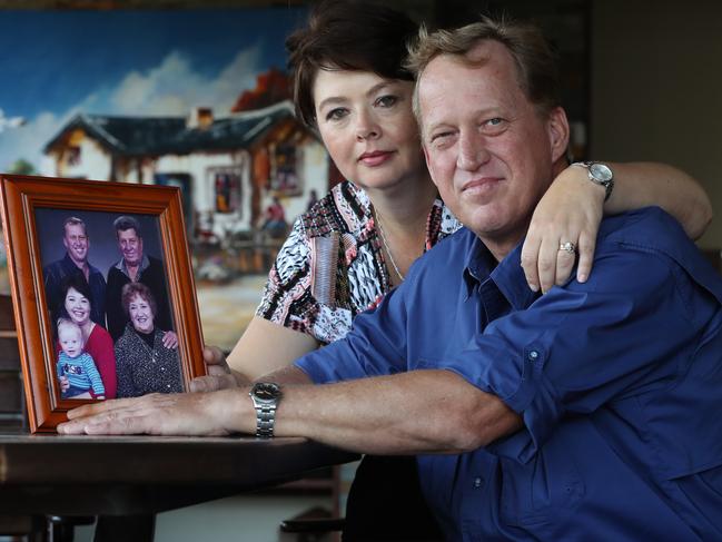 Arno Nel, with his wife Yolandi,  is the author of a letter to Peter Dutton being passed on by Coalition MPs that proposes a way to relocate South African farmers to Australia, at their home in Birkdale, Brisbane. Arno also has a tragic story about his parents , Louis and Alet (in the 8 yr old family photograph) who were attacked in South Africa. His father died on Sunday from complications arising from the attack. Lyndon Mechielsen/The Australian