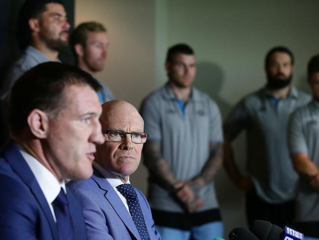 Sharks captain and Sharks CEO Barry Russell surrounded by senior players in a show of support after Flanagan was deregistered by the NRL. Picture: Brett Costello