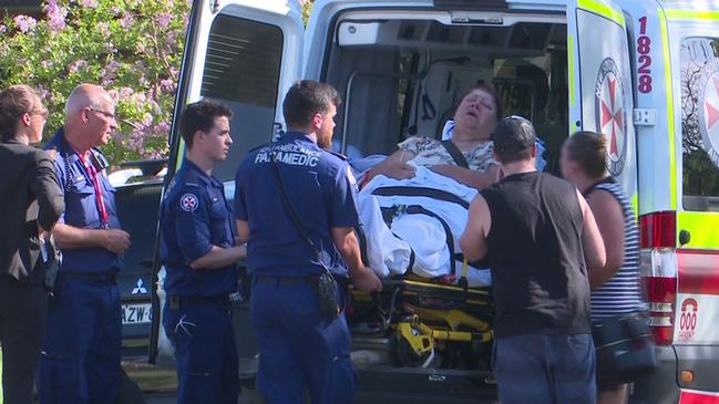 A woman is loaded into an ambulance at the Chester Hill home. Picture: TNV