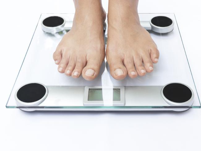 Generic photo of feet on bathroom scales. Picture: iStock