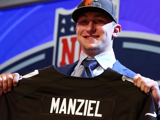 NEW YORK, NY - MAY 08: Johnny Manziel of the Texas A&M Aggies poses with a jersey after he was picked #22 overall by the Cleveland Browns during the first round of the 2014 NFL Draft at Radio City Music Hall on May 8, 2014 in New York City. (Photo by Elsa/Getty Images)