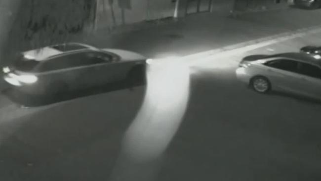 The white Audi is seen speeding into the laneway before the shooting.