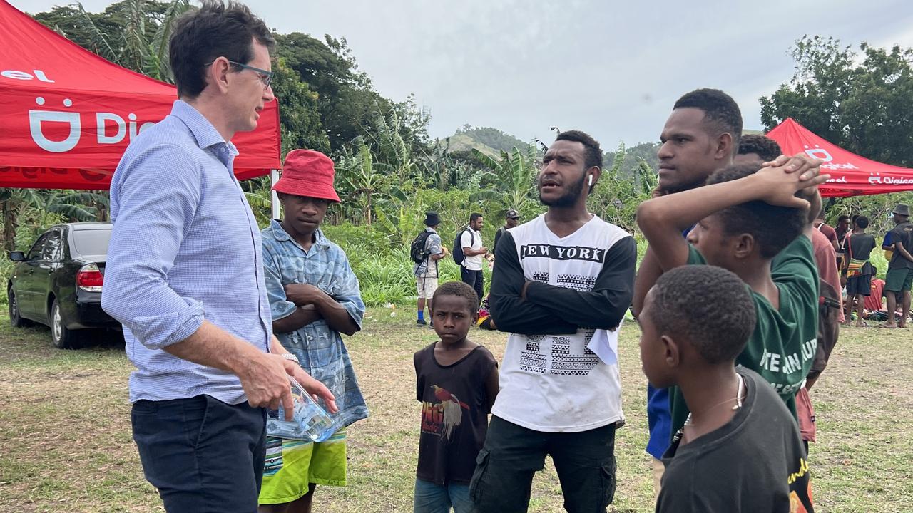 Queensland Rugby League CEO Ben Ikin talks with football fans during a visit to Papua New Guinea.