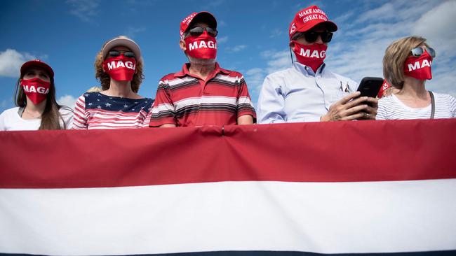 Supporters listen as Donald Trump speaks at a rally in Greenville, North Carolina, on Friday (AEDT). Picture: AFP)