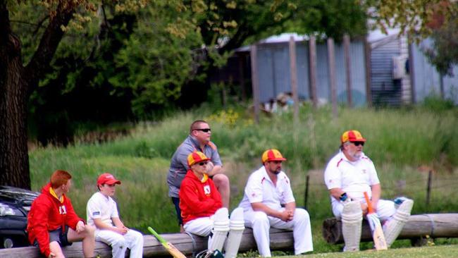 Hanging Rock cricketers wait for their turn to bat.