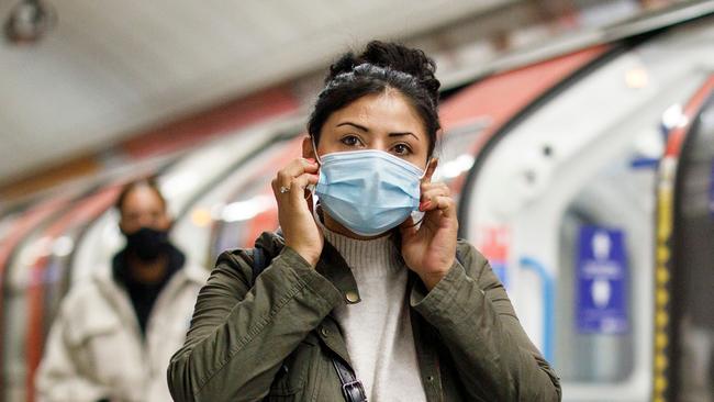 Commuters wear face-masks during morning rush hour on the Victoria Line of the London Underground. Picture: AFP