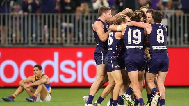 Dockers players mob Michael Walters after his post-siren point gave Fremantle a one-point win over Brisbane. Picture: Paul Kane/Getty Images