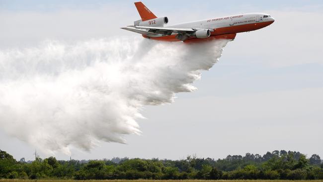 A NSW Rural Fire Service Very Large Air Tanker (VLAT) conducts a water drop test after being officially named at RAAF base Richmond, in Sydney. Picture: AAP