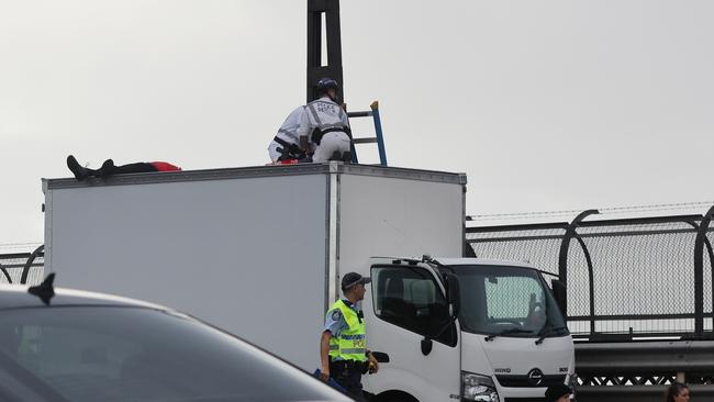 Police say two protesters got on top of a truck to disrupt traffic. Picture: David Swift