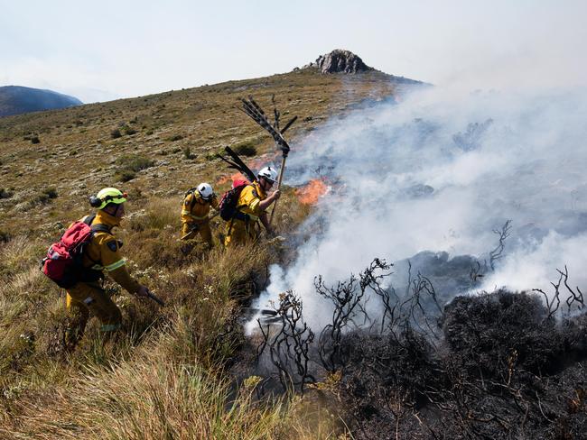 Tasmania Fire Service firefighters tackle the edge of the fire at Gell River. Picture: WARREN FREY/TASMANIA FIRE SERVICE