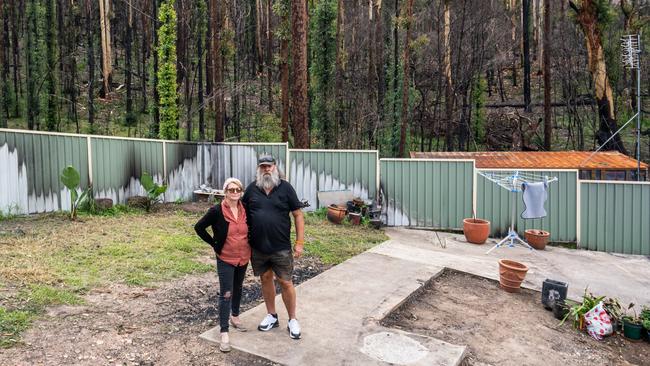 Chris and Michelle Darman on the site of their burned down home. Picture: Josh Burkinshaw