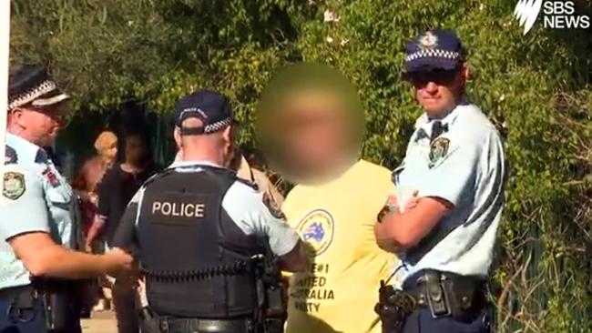 A United Australia Party supporter handing out how to vote cards in Bankstown in Sydney was fined for allegedly exposing himself at a polling booth this morning. Picture: SBS