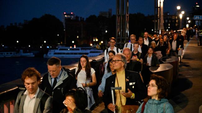 Members of the public queue on Lambeth Bridge in London to view the coffin of Britain's Queen Elizabeth II, lying in state at Westminster Hall.