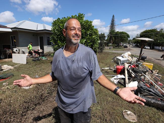 Manuel Halicos emptying his flooded house in Fairfield. Picture: Liam Kidston