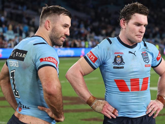 SYDNEY, AUSTRALIA - JUNE 05:  James Tedesco and Liam Martin of the Blues react after losing game one of the 2024 Men's State of Origin Series between New South Wales Blues and Queensland Maroons at Accor Stadium on June 05, 2024 in Sydney, Australia. (Photo by Cameron Spencer/Getty Images)