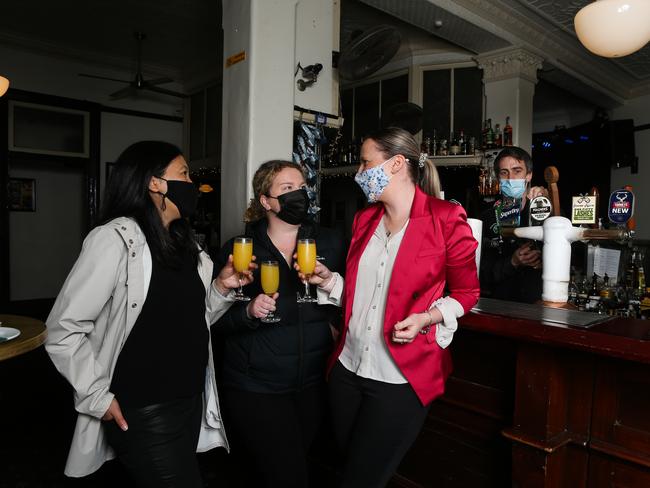 Amy Leanfore, Jenna McMurray, Monique O'Hallohan enjoy their first beer back at the Mercantile Pub in the Rocks as Pubs reopen in Sydney on "Freedom Day". Picture: NCA NewsWire/Gaye Gerard