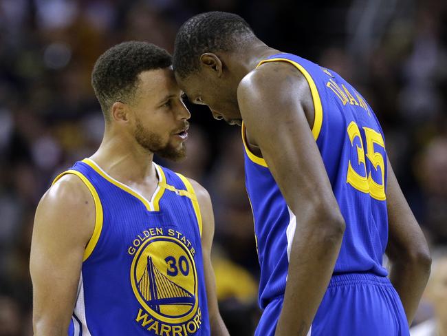 Golden State Warriors' Stephen Curry, left, and Kevin Durant talk in the final moments against the Cleveland Cavaliers in Game 3 of basketball's NBA Finals in Cleveland, Wednesday, June 7, 2017. Golden State won 118-113. (AP Photo/Tony Dejak)