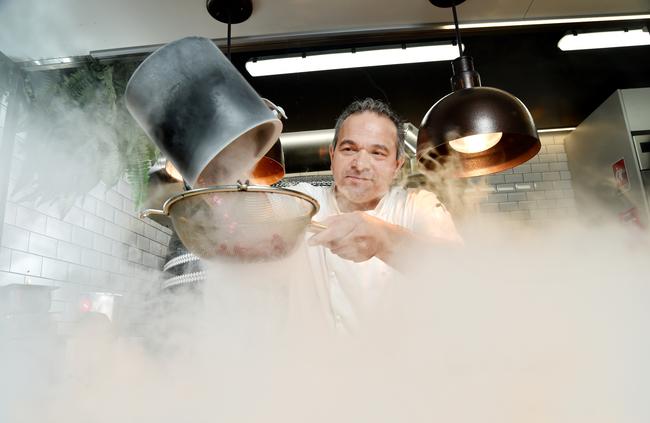 Chef Fabio De Lutiis freezes coulis in liquid nitrogen at the Macquarie University UBar for his creative dessert pizza. Pictures: Troy Snook