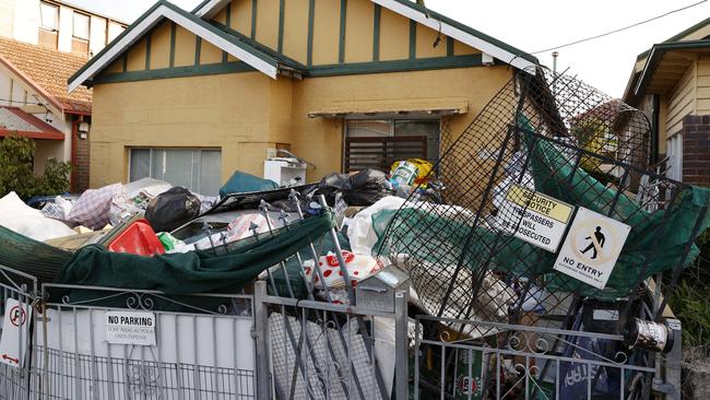 The hoarder house on Barnsbury Grove in Dulwich Hill, where the piles of rubbish almost cover two cars. Picture: Jonathan Ng