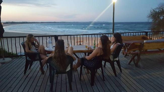 Elly Rose Warren with friends on the deck of Casa Barry Lodge, where she had been staying while volunteering in Tofo. This is the last picture her parents have of her alive. Picture: Supplied