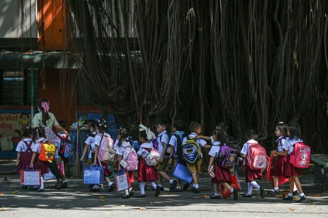 Students leave school in Manila after classes are suspended due to extreme heat