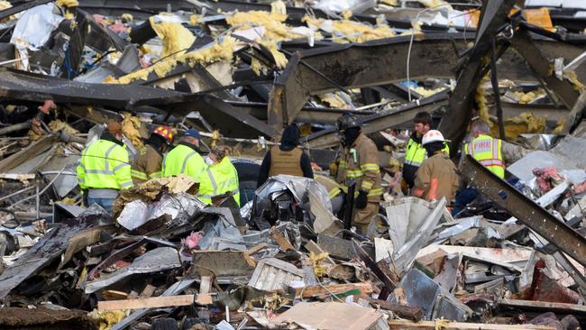 Emergency workers search what is left of the Mayfield Consumer Products Candle Factory after it was destroyed by a tornado in Mayfield, Kentucky.