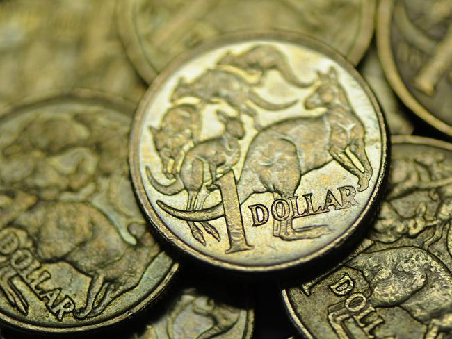 Close-up of used Australian one dollar coin photographerd in Melbourne, Wednesday, June 13, 2012. Reserve Bank of Australia governor Glenn Stevens today said there are big benefits to Australian's as consumers from the high Aiustralian dollar (AUD). (AAP Image/Julian Smith) NO ARCHIVING