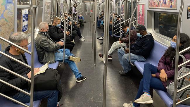 Commuters wearing masks ride the New York City Subway. Picture: AFP