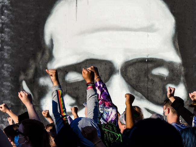 People raise their hands as they protest at the makeshift memorial in honour of George Floyd in Minneapolis, Minnesota. Picture: AFP