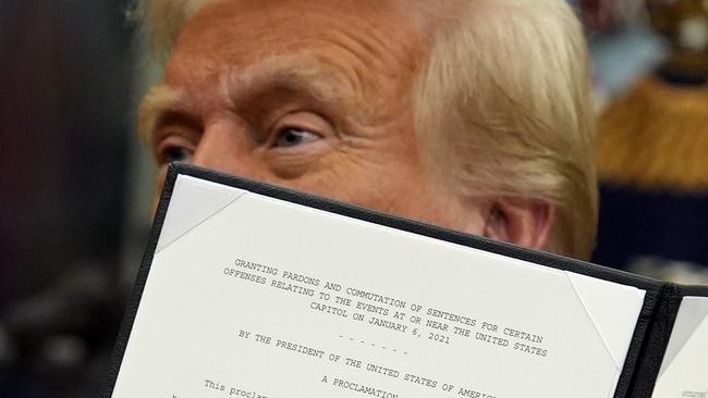 President Donald Trump signs an executive order pardoning about 1500 defendants charged in the January, 2021, attack on the US Capitol. Picture: AP