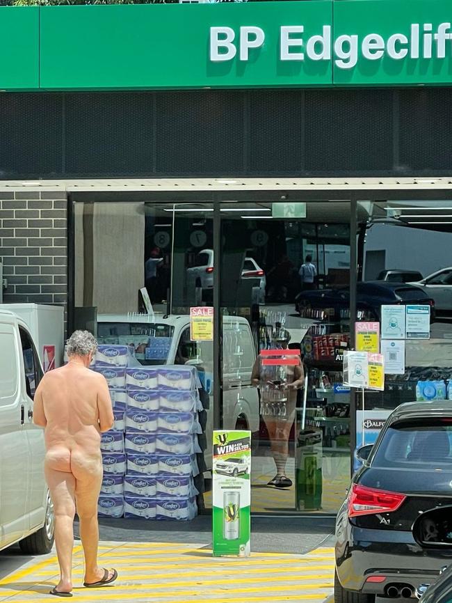 A naked man pays for his fuel at a busy petrol station in Sydney’s east. Picture: Bruno Bouchet