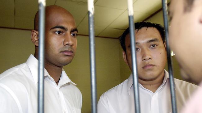 Myuran Sukumaran (l) with Tach Duc Thanh Nguyen talking to lawyer in a jail cell in Denpasar, before their trial in Bali, Indonesia dated November 22, 2005.