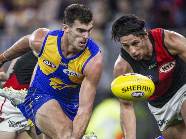 Scott Lycett of the Eagles and Mark Baguley of the Bombers contest the ball during the Round 14 AFL match between the West Coast Eagles and the Essendon Bombers at Optus Stadium in Perth, Thursday, June 21, 2018. (AAP Image/Tony McDonough) NO ARCHIVING, EDITORIAL USE ONLY