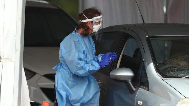 A health worker performs a Covid test. Picture: Chris Hyde