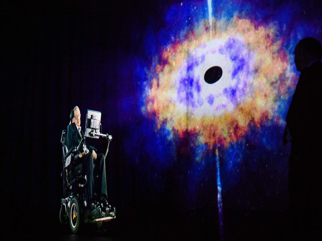 Physicist Stephen Hawking, 75, speaks to an audience by hologram (L) in Hong Kong, beamed live from his office in Cambridge, England. Picture: AFP