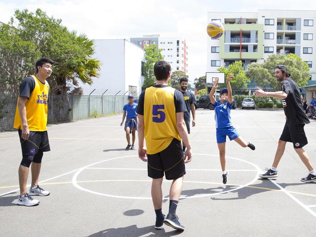 Fairfield Advance - Pictured: Action shots - Several Sydney Kings basketball players visited Fairfield Public School today to play some of the school basketball team members (permissions are a problem - some team members couldn't be identified, hence only two shots of students who can). 68-82 Smart Street, Fairfield NSW Australia