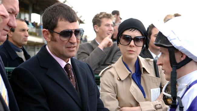 Jonathan Munz speaks with jockey Craig Newitt at Flemington.