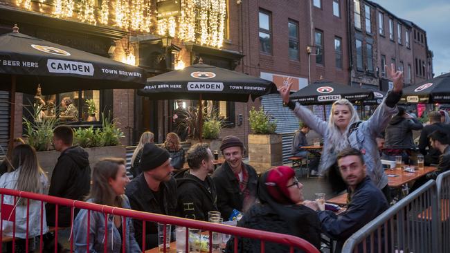 Revllers enjoy a tipple at a bar in Manchester, England.