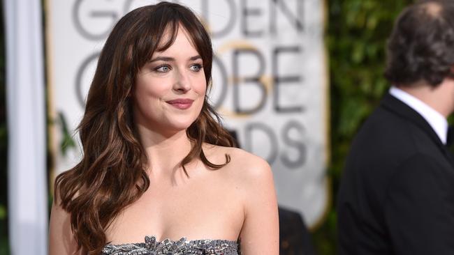 Dakota Johnson arrives at the 72nd annual Golden Globe Awards at the Beverly Hilton Hotel on Sunday, Jan. 11, 2015, in Beverly Hills, Calif. (Photo by John Shearer/Invision/AP)