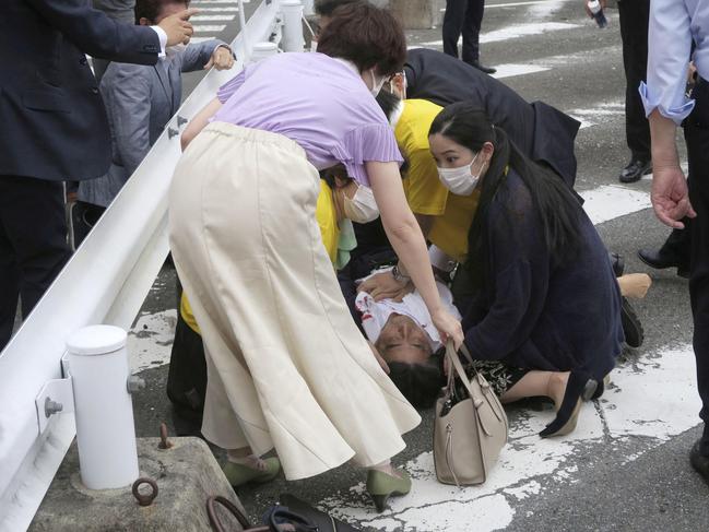 Former Japanese prime minister Shinzo Abe lies on the ground after apparent shooting.