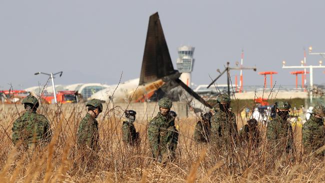 South Korean soldiers work at the wreckage. Picture: Chung Sung-Jun/Getty Images