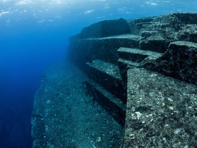 ONE TIME WEB USE FOR NEWS.COM.AU ONLY - FEES APPLY - MUST DOWNLOAD ON OWN ALAMY ACCOUNT FOR ANY FUTURE USE -  2XFWM1X Scuba diver exploring the Yonaguni Monument, a submerged rock formation off the coast of Japan. It is unknown if these sandstone rocks are formed naturally or are of human construction, Yoguni, Japan. 2017.  Picture: Alamy